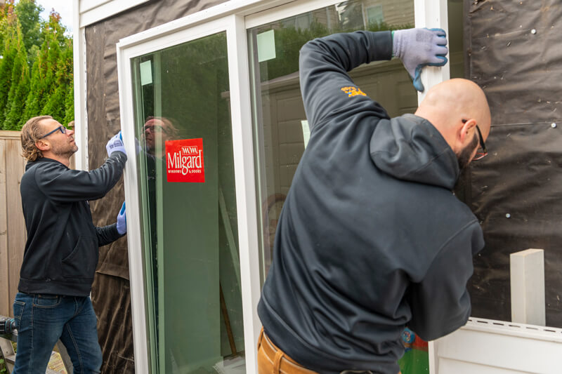 Apex Glass Technicians Installing New Milgard Sliding Door